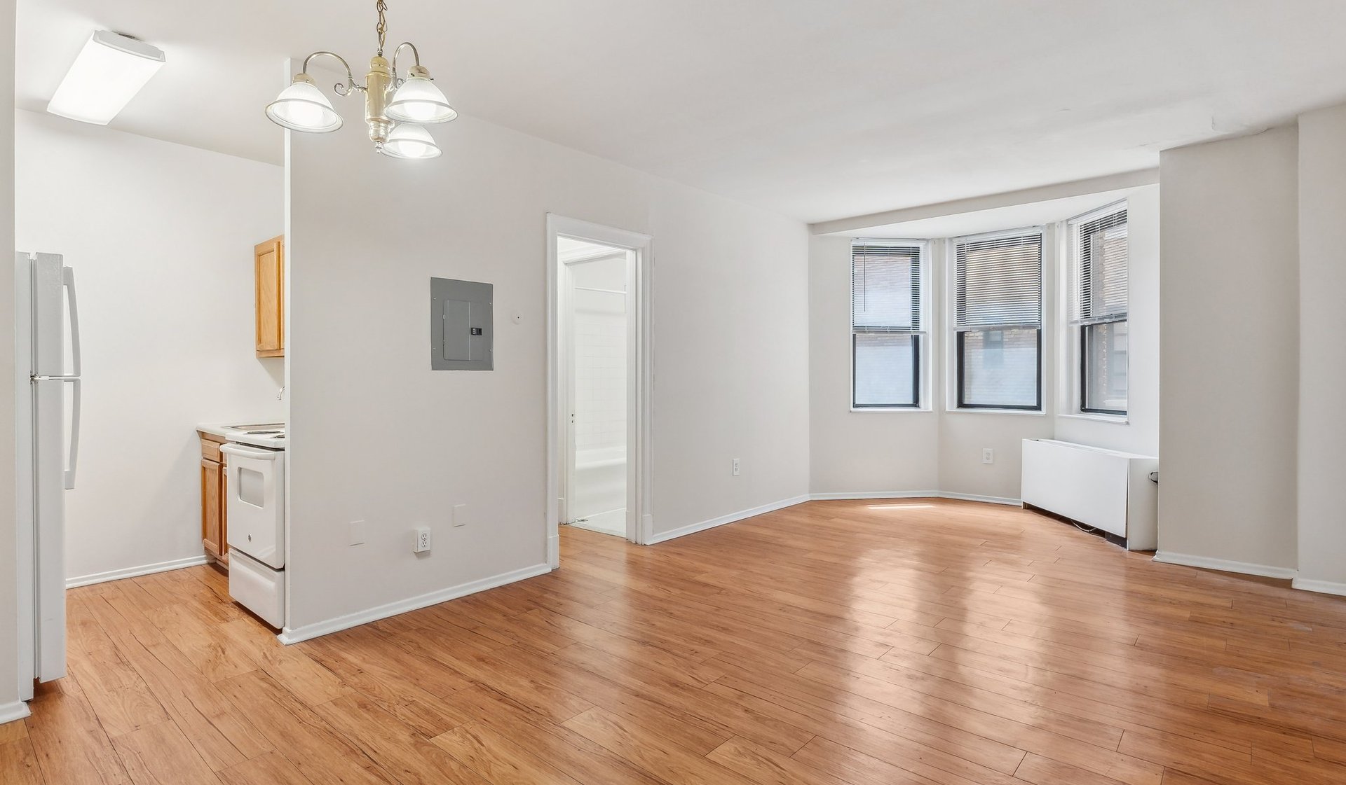 Spacious living space with natural light and wood flooring