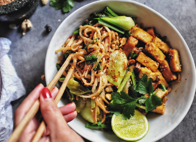 Chestnut Hall Apartments | Philadelphia, PA | Person eating Thai noodles with chopsticks